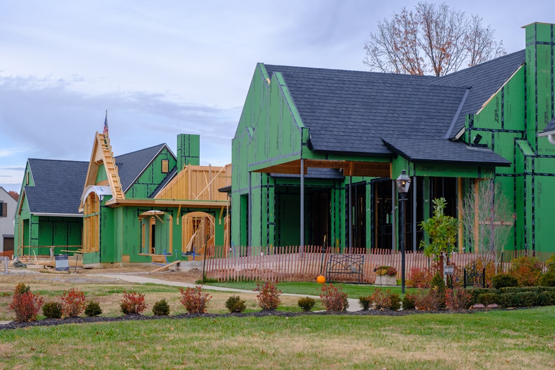 A photo showing a Kansas house build cost breakdown chart with categories like site work, foundation, framing, MEP, finishes, and permits