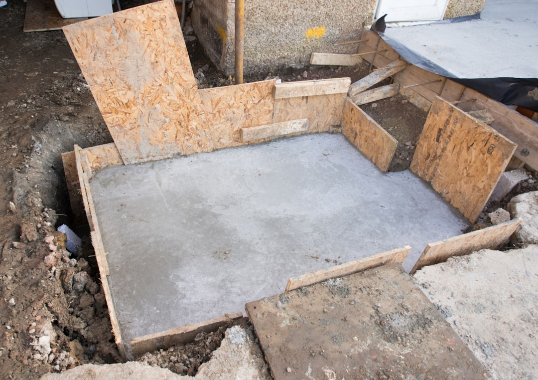 A side-by-side comparison visual of slab-on-grade vs crawlspace foundations with labels for cost drivers like excavation, footings, moisture control, and framing
