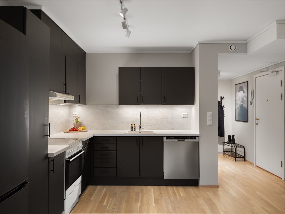 A side-by-side comparison photo of standard vs upgraded interior finishes: cabinets, countertops, flooring, and lighting