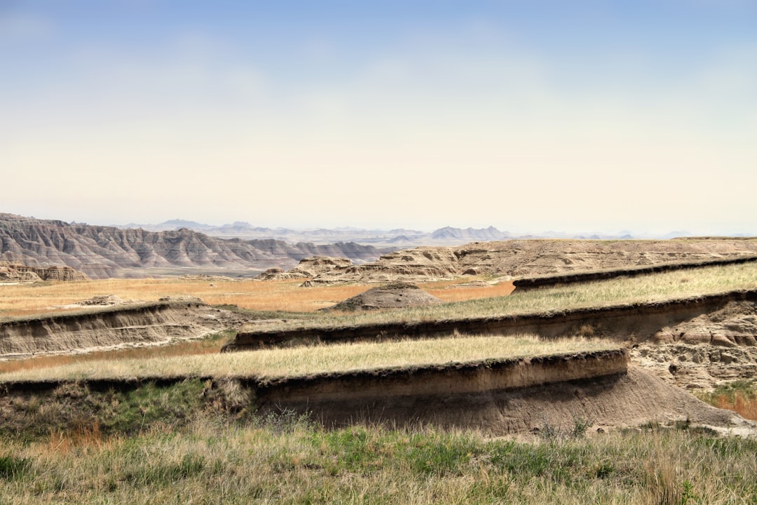 Photo showing two South Dakota job sites—one suburban flat lot and one rural acreage with longer utility runs