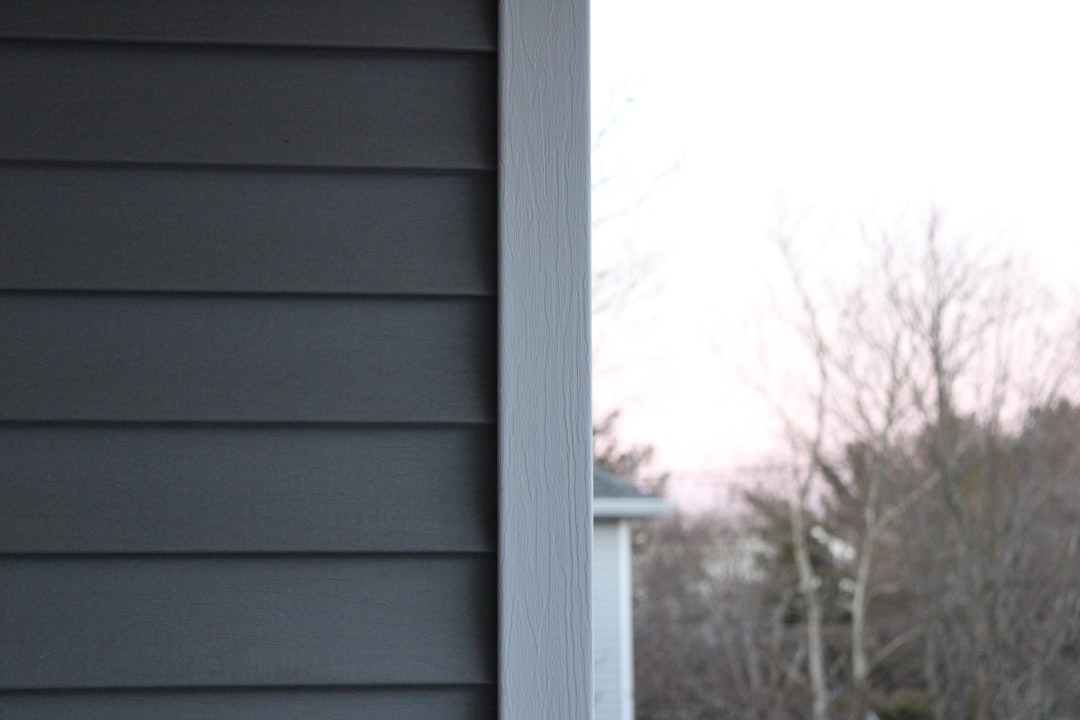 Comparison photo showing lap fiber cement siding vs vinyl siding profiles on a new build